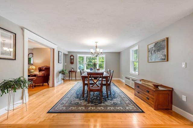 2470 W St, Wrentham, MA 02093 - dining area featuring a chandelier, light wood finished floors, and baseboards