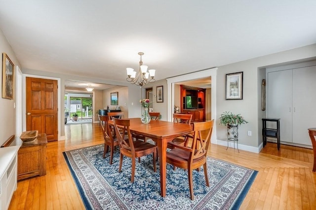 2470 W St, Wrentham, MA 02093 - dining room with light wood-style floors, a chandelier, and baseboards