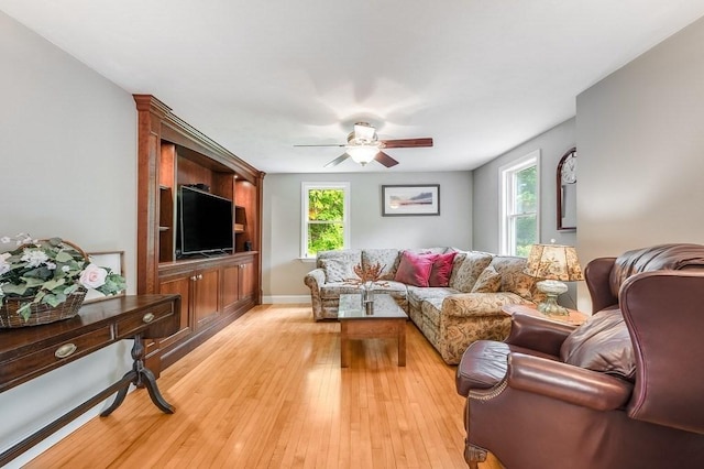 2470 W St, Wrentham, MA 02093 - living room with a ceiling fan, light wood-style flooring, and baseboards