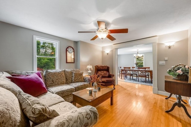 2470 W St, Wrentham, MA 02093 - living room featuring plenty of natural light, ceiling fan, a chandelier, and light wood-style floors