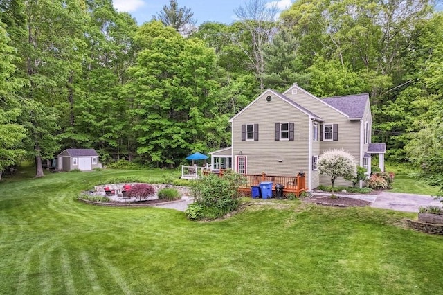 2470 W St, Wrentham, MA 02093 - rear view of property with a deck, a lawn, and a view of trees