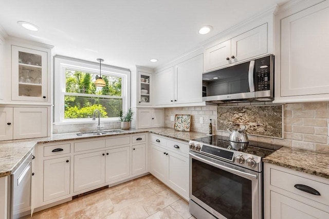 2470 W St, Wrentham, MA 02093 - kitchen with stainless steel appliances, a sink, white cabinets, backsplash, and hanging light fixtures