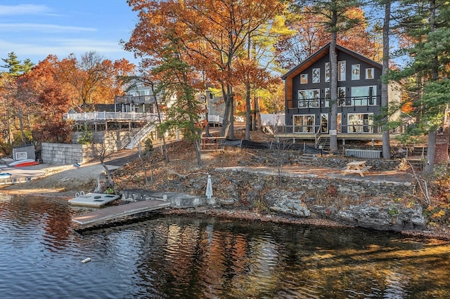 rear view of property with a deck with water view