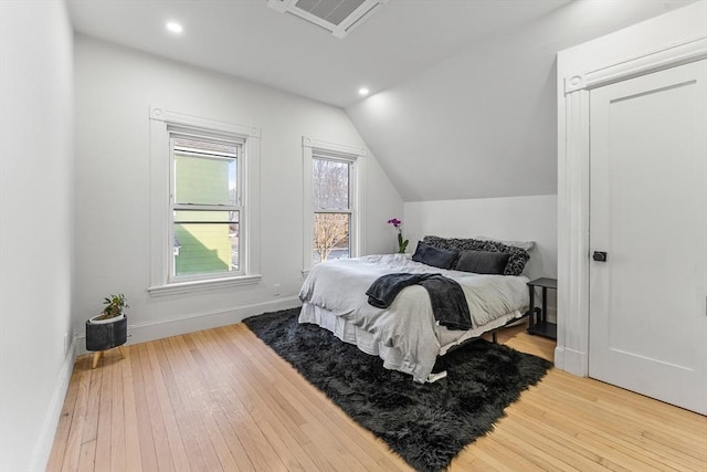 bedroom with hardwood / wood-style flooring and vaulted ceiling