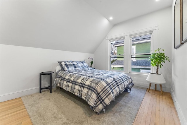 bedroom featuring wood-type flooring and lofted ceiling