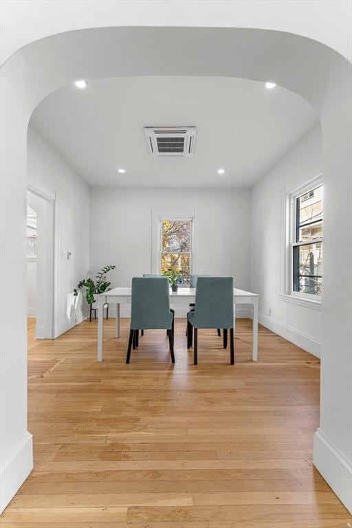 dining room with light hardwood / wood-style flooring and plenty of natural light