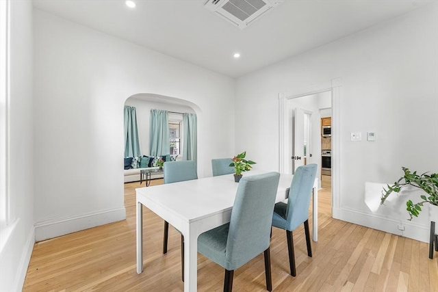 dining space with light hardwood / wood-style floors