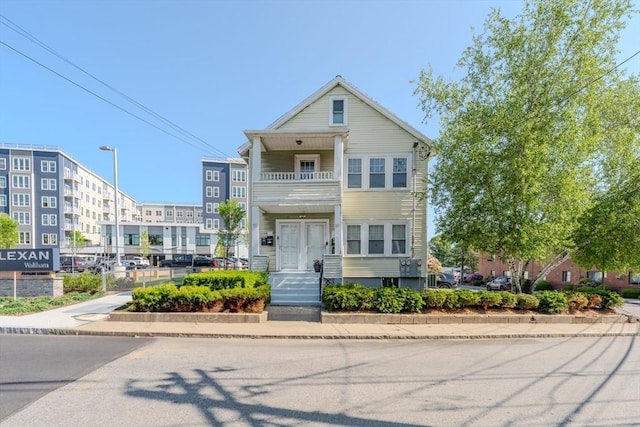 69-71 Pond St, Waltham, MA 02451 - townhome / multi-family property featuring a balcony