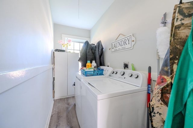 69-71 Pond St, Waltham, MA 02451 - laundry room with independent washer and dryer, light wood-type flooring, and attic access