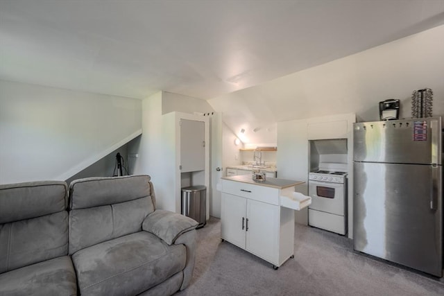 69-71 Pond St, Waltham, MA 02451 - kitchen featuring freestanding refrigerator, open floor plan, white electric stove, light carpet, and vaulted ceiling