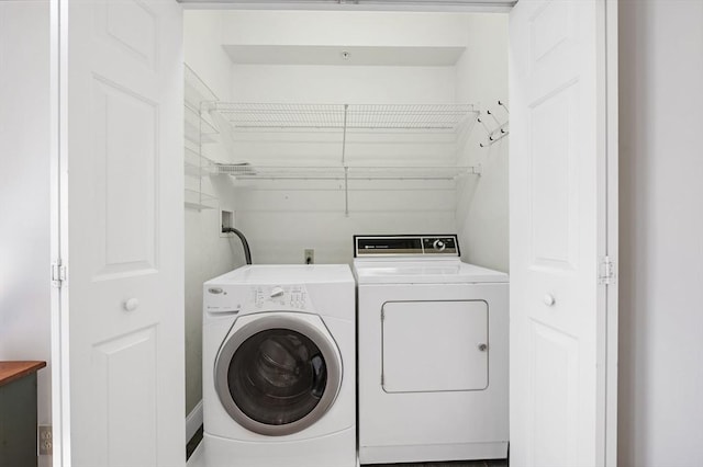 laundry room featuring washing machine and clothes dryer and laundry area