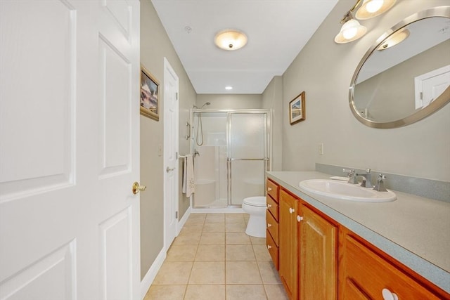 full bathroom featuring toilet, tile patterned flooring, vanity, and a stall shower