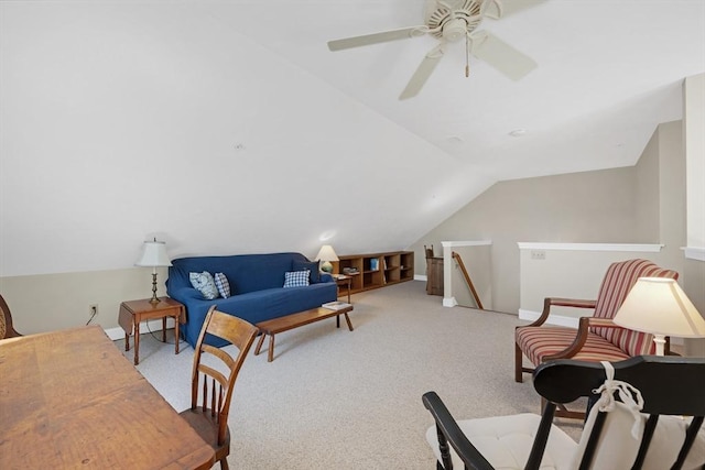 living area featuring carpet flooring, baseboards, lofted ceiling, and ceiling fan