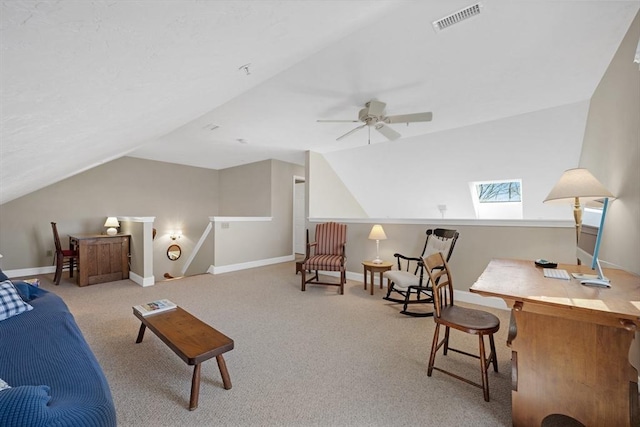 interior space with vaulted ceiling with skylight, baseboards, and visible vents