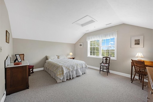 bedroom featuring light carpet, lofted ceiling, attic access, and baseboards