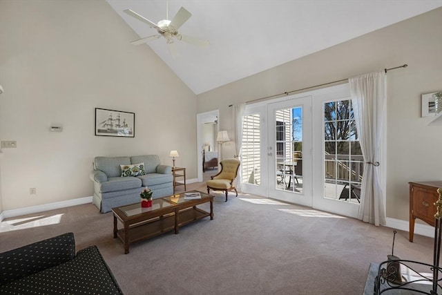 carpeted living room with ceiling fan, baseboards, and high vaulted ceiling