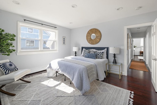 bedroom featuring recessed lighting, wood finished floors, and baseboards