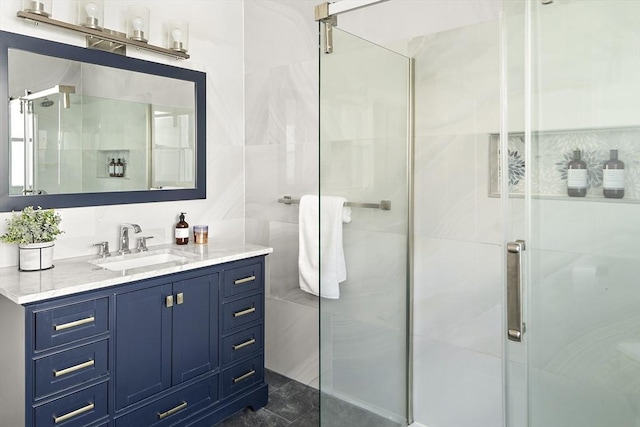 bathroom with vanity, tile walls, and a stall shower