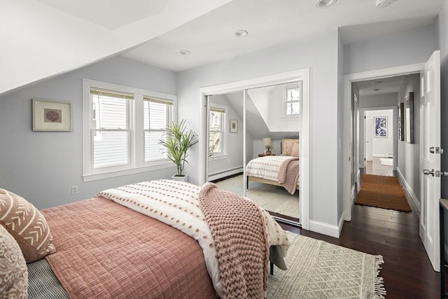 bedroom featuring lofted ceiling, dark wood-type flooring, baseboards, and a baseboard radiator