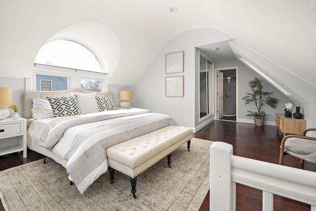 bedroom featuring lofted ceiling, wood finished floors, and baseboards