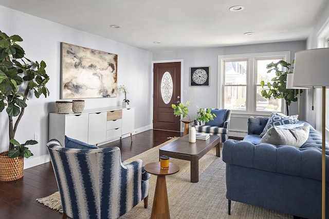 living room featuring recessed lighting, dark wood-type flooring, baseboards, and a baseboard radiator