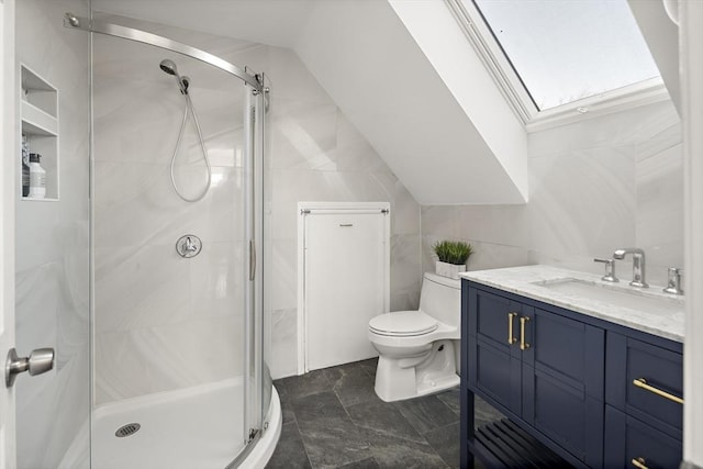 bathroom featuring toilet, a stall shower, tile walls, lofted ceiling, and vanity