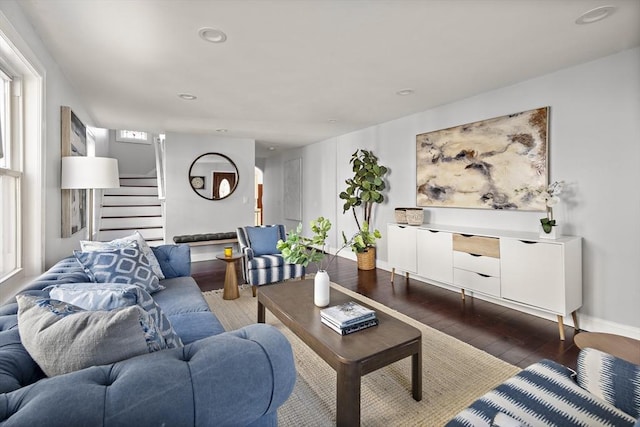 living area with stairs, recessed lighting, baseboards, and dark wood-style flooring