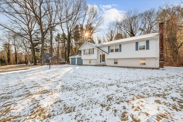 raised ranch featuring an outbuilding