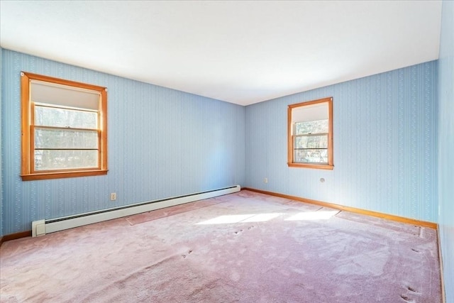 unfurnished room featuring a baseboard radiator and light carpet