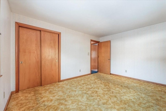 unfurnished bedroom with a closet and carpet