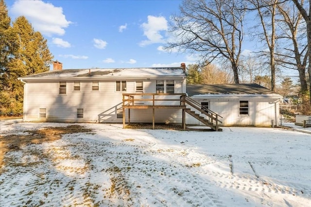 snow covered house featuring a deck