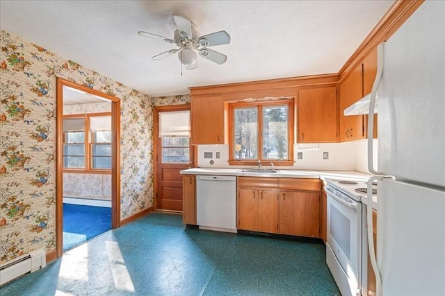 kitchen featuring ceiling fan, sink, white appliances, and baseboard heating