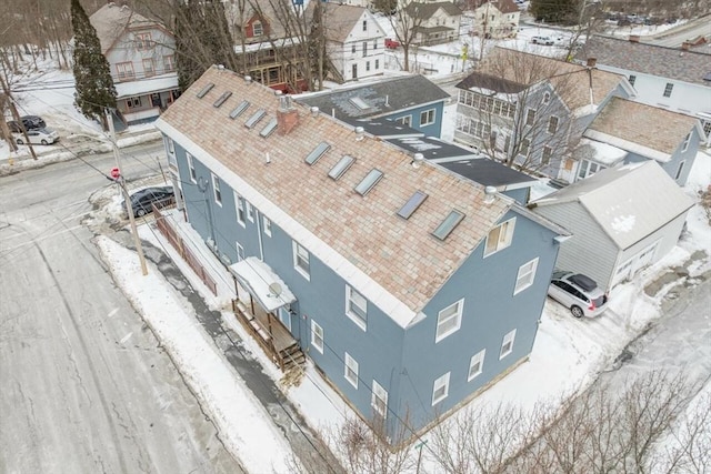 snowy aerial view with a residential view