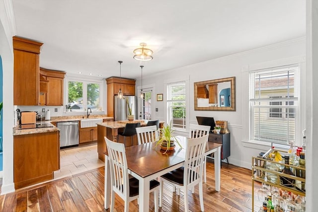 19 Brown Ct, Methuen, MA 01844 - dining space featuring light wood-style floors, ornamental molding, and baseboards