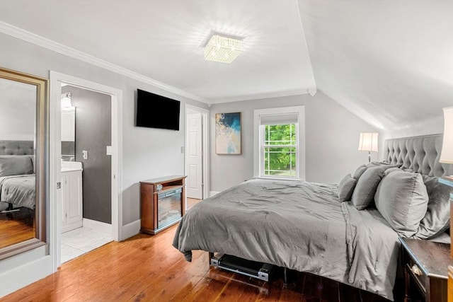 19 Brown Ct, Methuen, MA 01844 - bedroom featuring light wood-style floors, ornamental molding, lofted ceiling, and connected bathroom