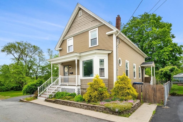 19 Brown Ct, Methuen, MA 01844 - victorian house featuring a chimney and a porch