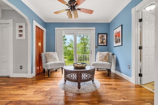 19 Brown Ct, Methuen, MA 01844 - sitting room featuring light wood-style flooring, baseboards, ornamental molding, ceiling fan, and arched walkways