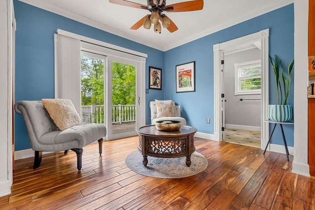 19 Brown Ct, Methuen, MA 01844 - living area featuring healthy amount of natural light, wood-type flooring, baseboards, crown molding, and ceiling fan