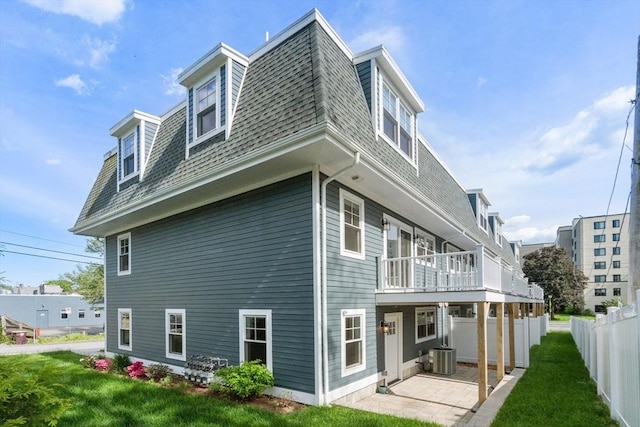 114 Broad St Unit D, Weymouth, MA 02188 - back of property featuring a patio, mansard roof, a balcony, and roof with shingles
