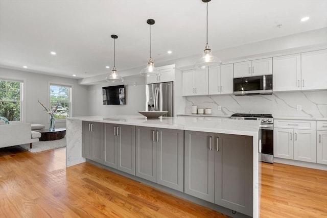 114 Broad St Unit D, Weymouth, MA 02188 - kitchen with appliances with stainless steel finishes, light wood-style floors, gray cabinetry, white cabinets, and a spacious island