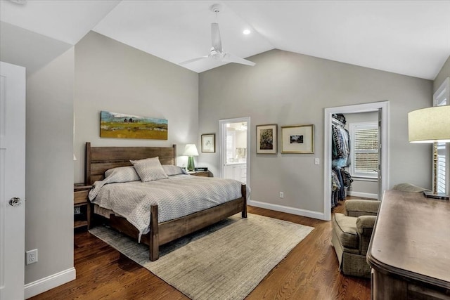 bedroom with ensuite bath, dark hardwood / wood-style floors, a spacious closet, vaulted ceiling, and a closet