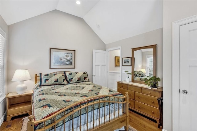 bedroom with hardwood / wood-style flooring and vaulted ceiling