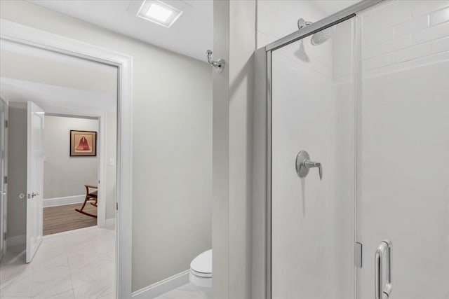 bathroom featuring an enclosed shower and toilet