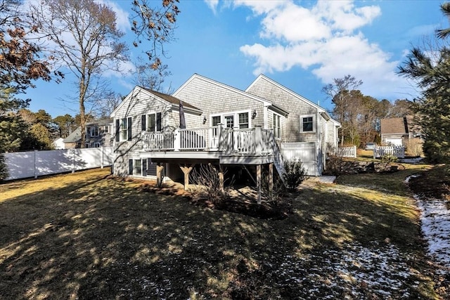 rear view of property featuring a wooden deck