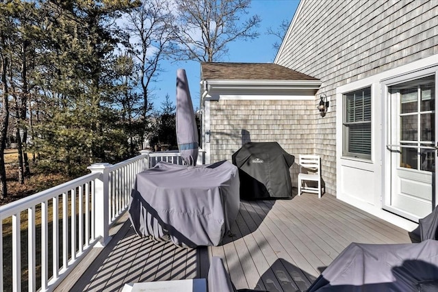 wooden terrace with a grill