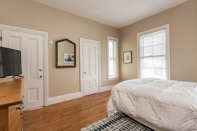 36 7th St, New Bedford, MA 02740 - bedroom featuring baseboards, light wood finished floors, and multiple windows