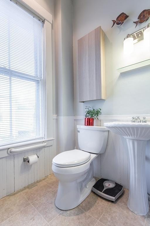 36 7th St, New Bedford, MA 02740 - bathroom with toilet, a wainscoted wall, and tile patterned floors