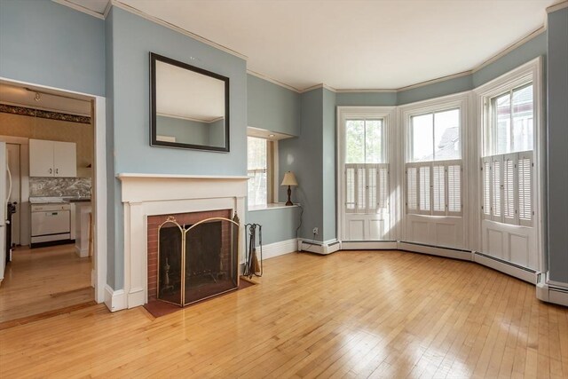 36 7th St, New Bedford, MA 02740 - unfurnished living room with ornamental molding, light wood-style flooring, plenty of natural light, a fireplace, and baseboards