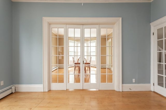 36 7th St, New Bedford, MA 02740 - empty room with french doors, baseboard heating, and wood finished floors