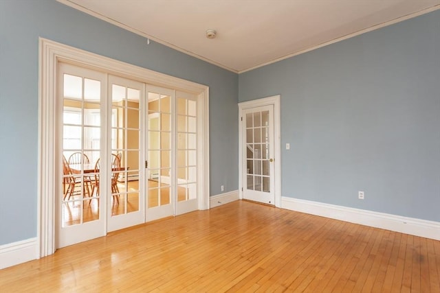 36 7th St, New Bedford, MA 02740 - spare room featuring ornamental molding, hardwood / wood-style floors, baseboards, and a smoke detector